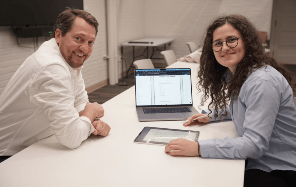 LabMODO team building the platform — Mike Gaumer working with a teammate at a laptop